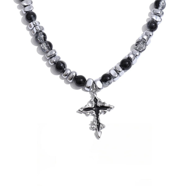 Gold-plated stainless steel necklace with black stone beads and a silver cross pendant.