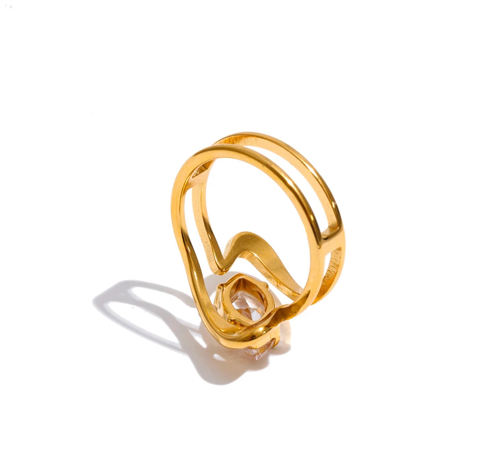 Cubic zirconia geometric ring in 18K gold-plated stainless steel with cubic zirconia.