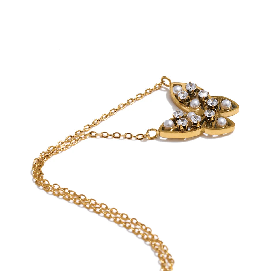 Cubic zirconia pearl butterfly necklace in gold-plated stainless steel with pearl and cubic zirconia.