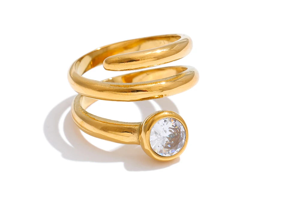 Cubic zirconia geometric layered ring in 18K gold-plated stainless steel with cubic zirconia.