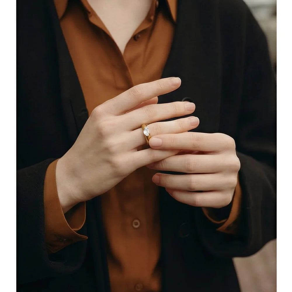 Cubic zirconia geometric ring in 18K gold-plated stainless steel with cubic zirconia.
