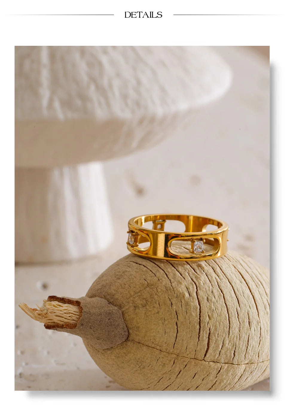 Cubic zirconia geometric ring in 18K gold-plated stainless steel with cubic zirconia.