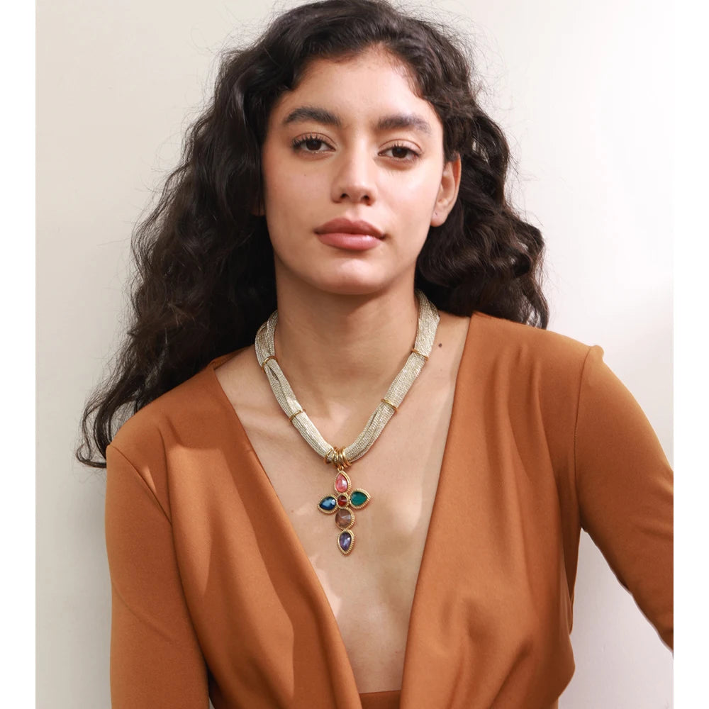 White glass cross necklace in gold-plated stainless steel.