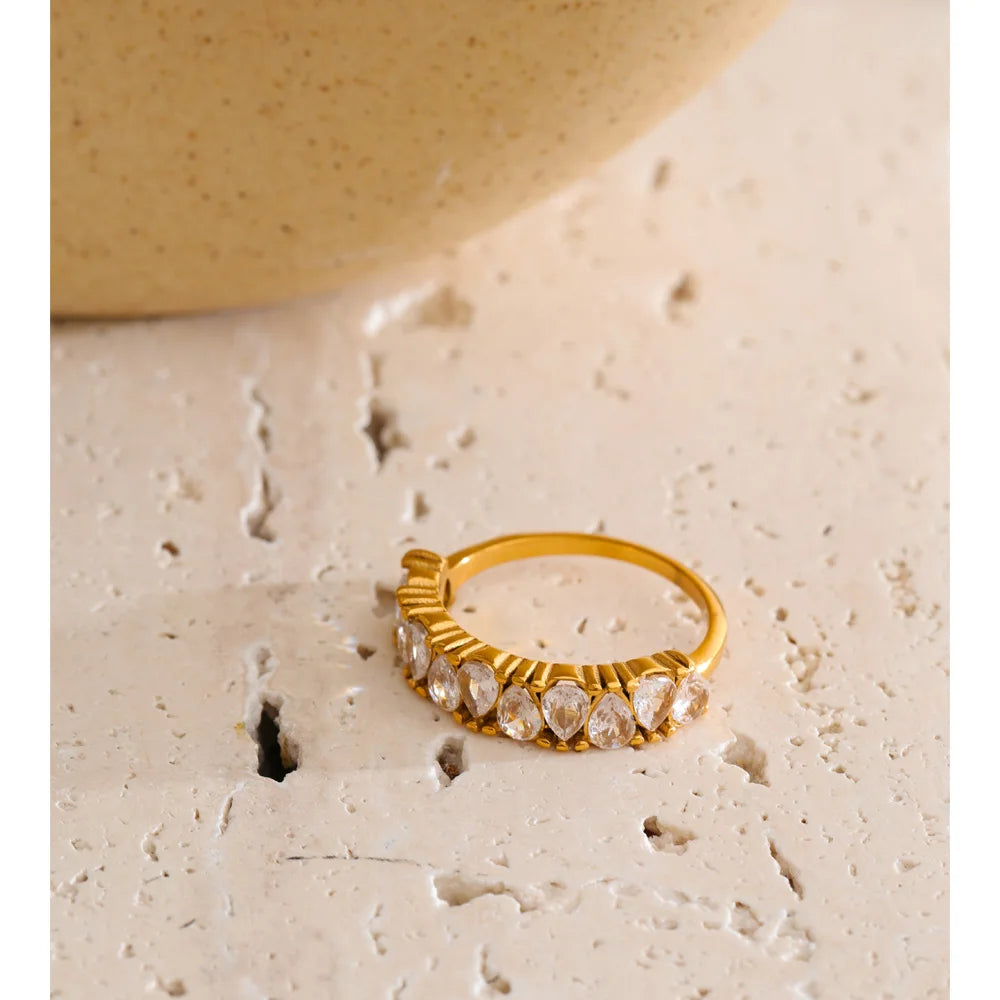 Cubic zirconia geometric ring in 18K gold-plated stainless steel with cubic zirconia.