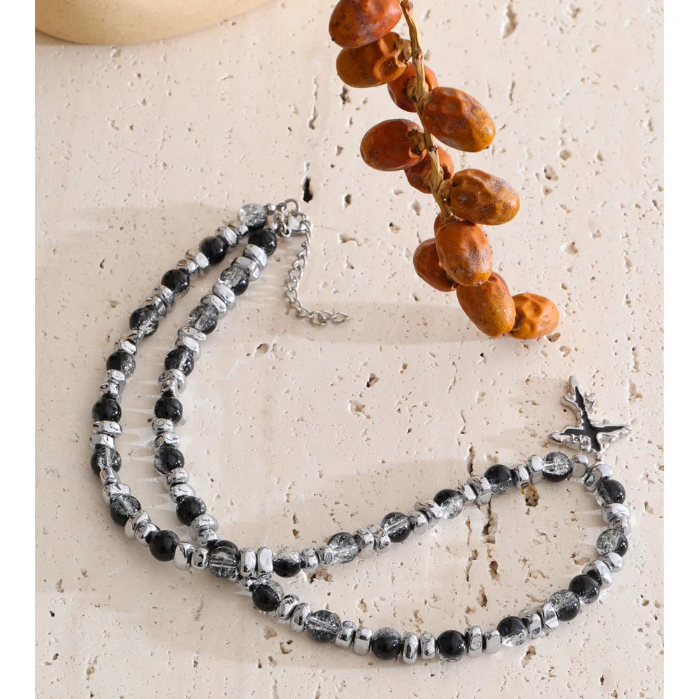 Natural stone cross beaded necklace in gold-plated stainless steel with natural stone.