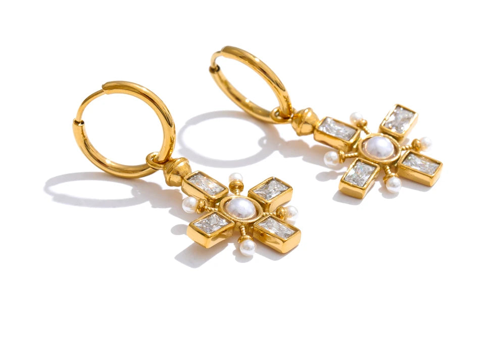 Cubic zirconia pearl cross earrings in gold-plated stainless steel with pearl and cubic zirconia.