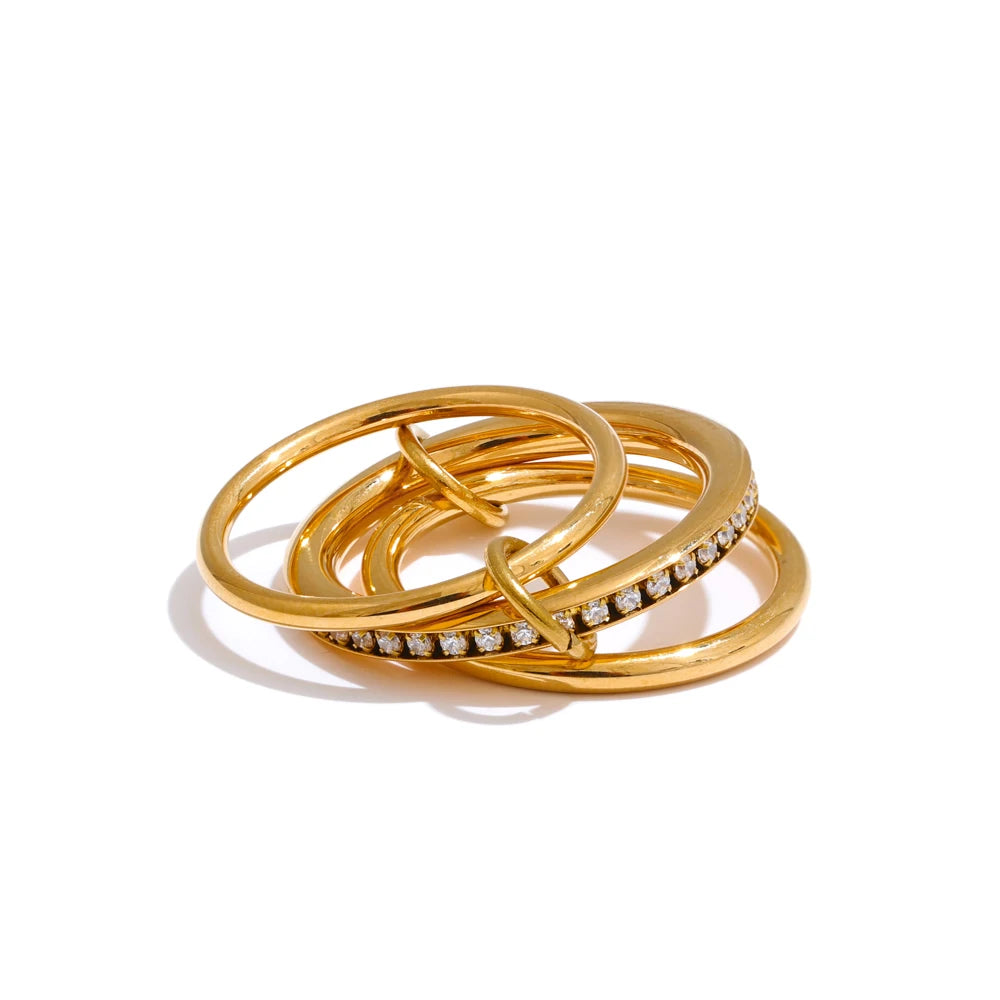Cubic zirconia geometric layered ring in 18K gold-plated stainless steel with cubic zirconia.