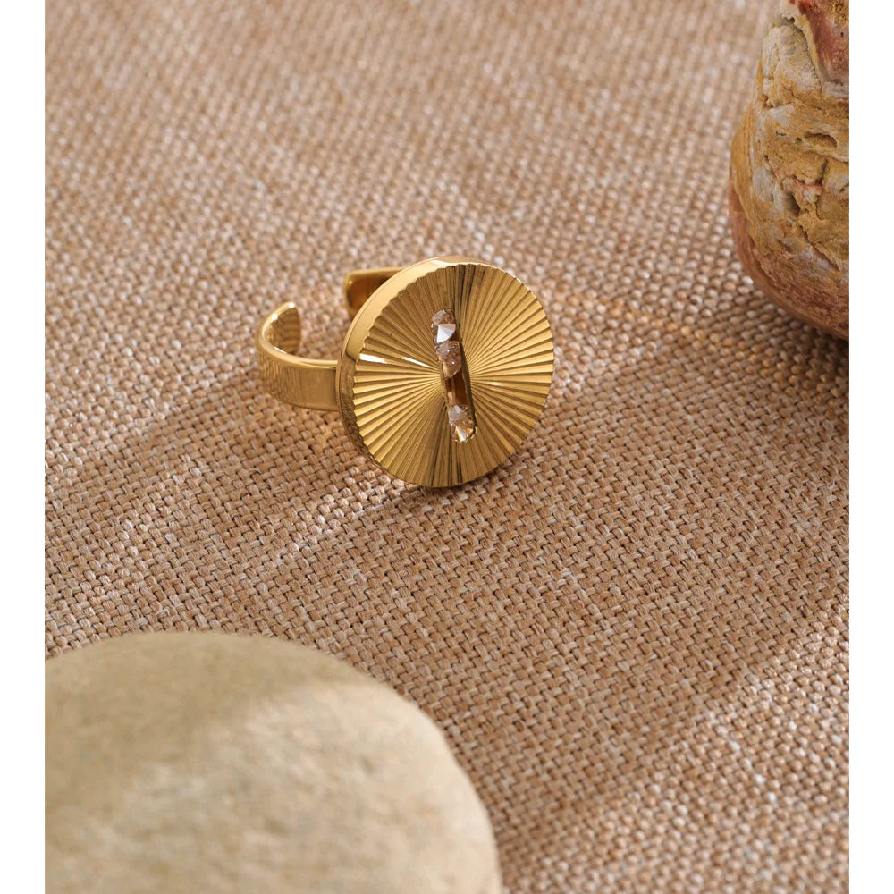 Cubic zirconia geometric ring in 18K gold-plated stainless steel with cubic zirconia.