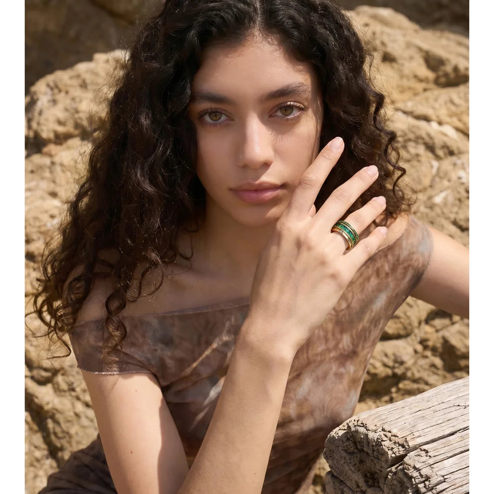 Cubic zirconia geometric layered ring in 18K gold-plated stainless steel with cubic zirconia.