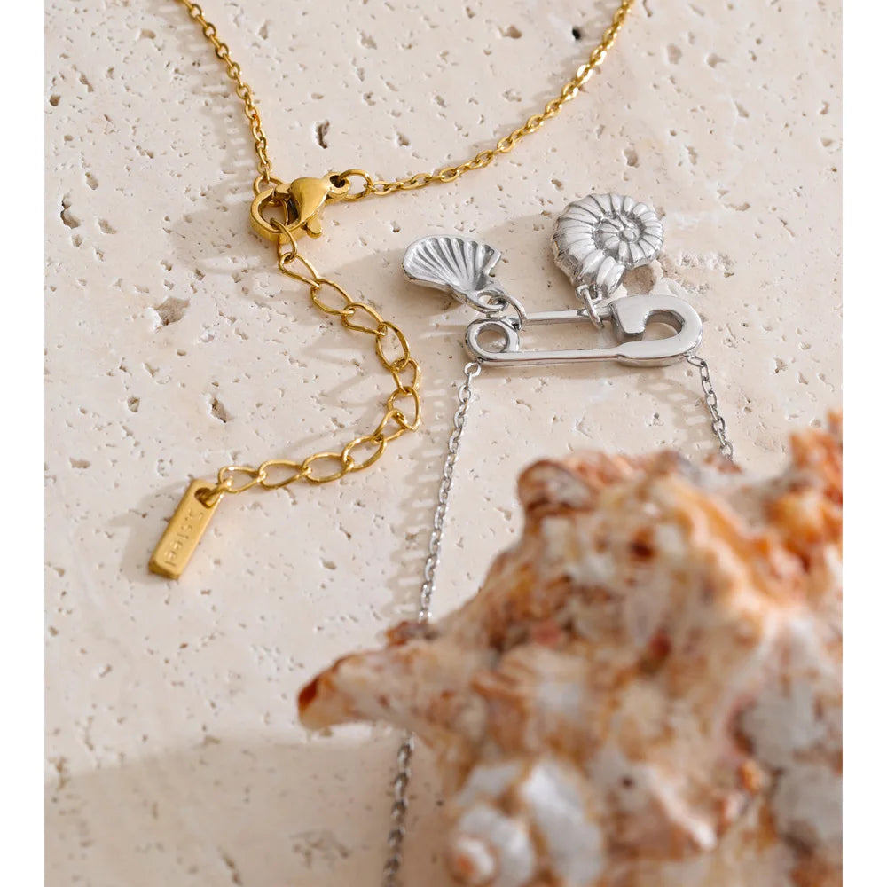 Cubic zirconia shell geometric necklace in gold-plated stainless steel with cubic zirconia and shell.