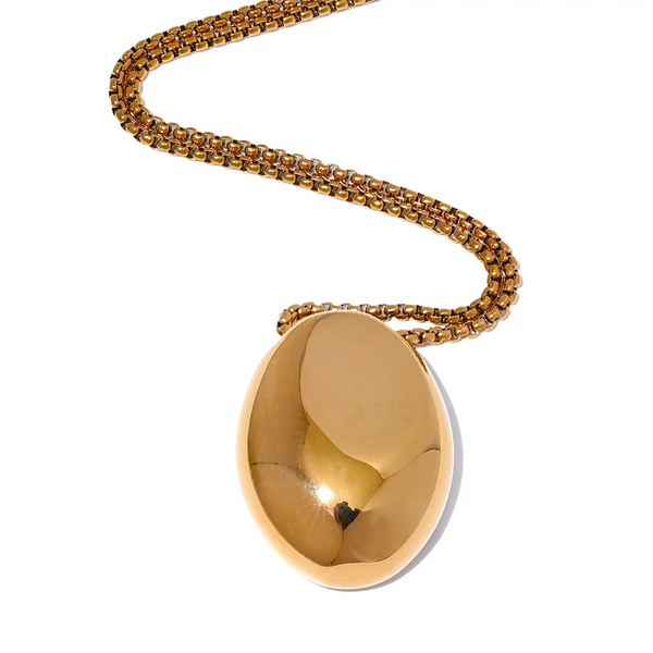 Gold-plated stainless steel necklace with a large oval pendant featuring a small hole in the center.