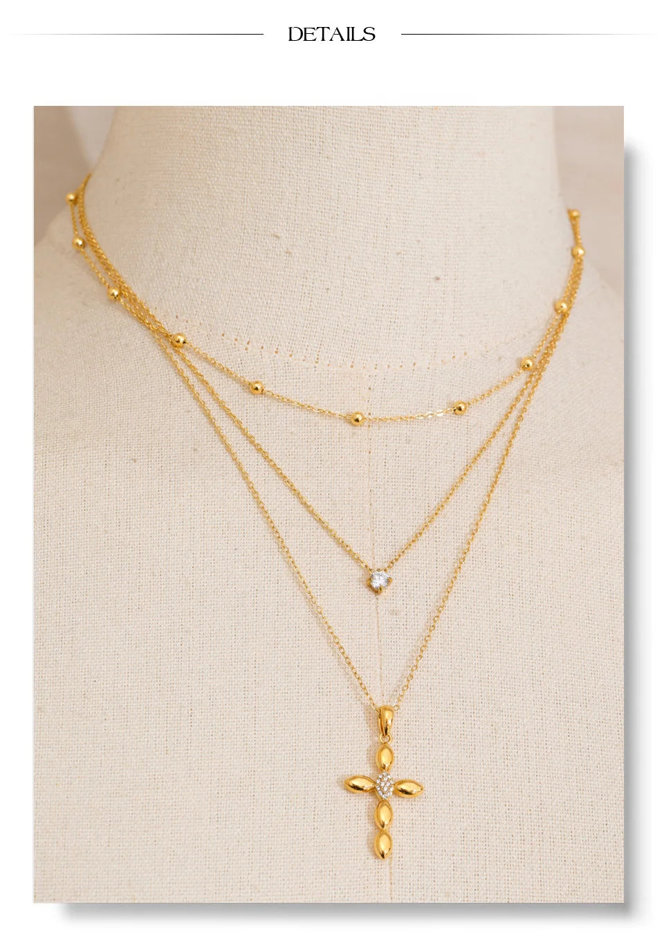 Cubic zirconia cross chain necklace in gold-plated stainless steel with cubic zirconia.