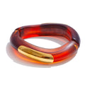 Resin acrylic multi-color bracelet in gold-plated stainless steel with resin and acrylic.