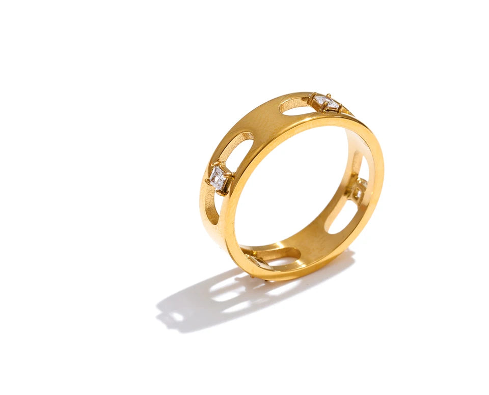 Cubic zirconia geometric ring in 18K gold-plated stainless steel with cubic zirconia.
