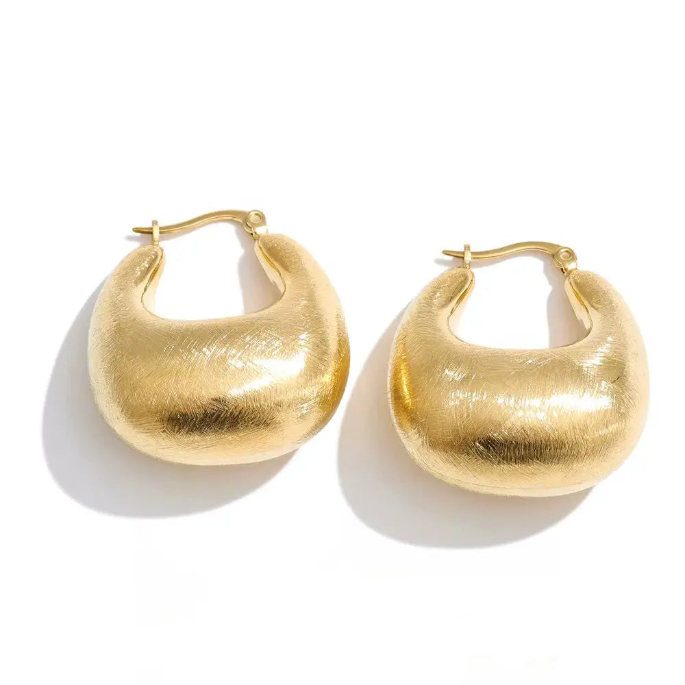 Gold-plated stainless steel earrings with a unique, round shape.