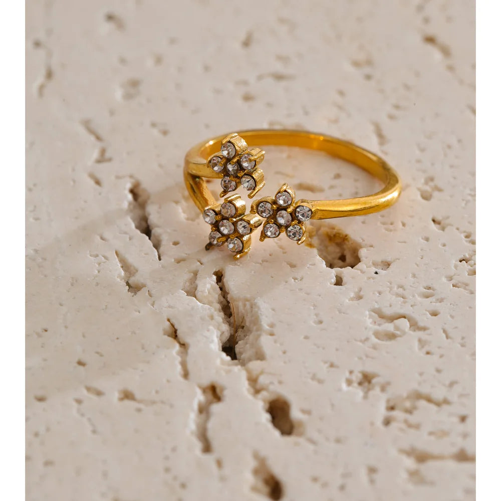 Cubic zirconia flower ring in 18K gold-plated stainless steel with cubic zirconia.