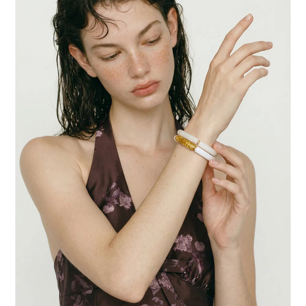 Resin acrylic geometric bracelet in gold-plated stainless steel with resin and acrylic.