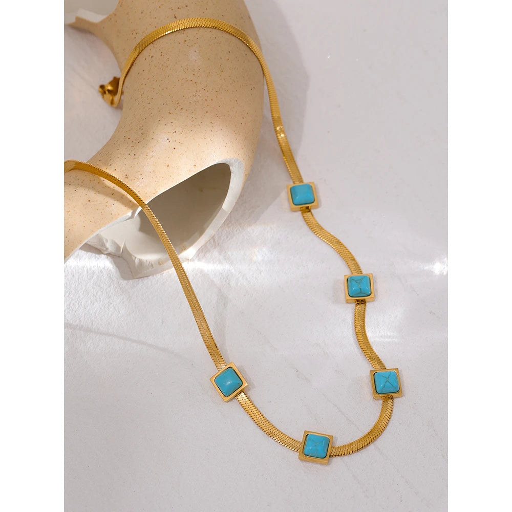 Gold-plated necklace with blue stones.