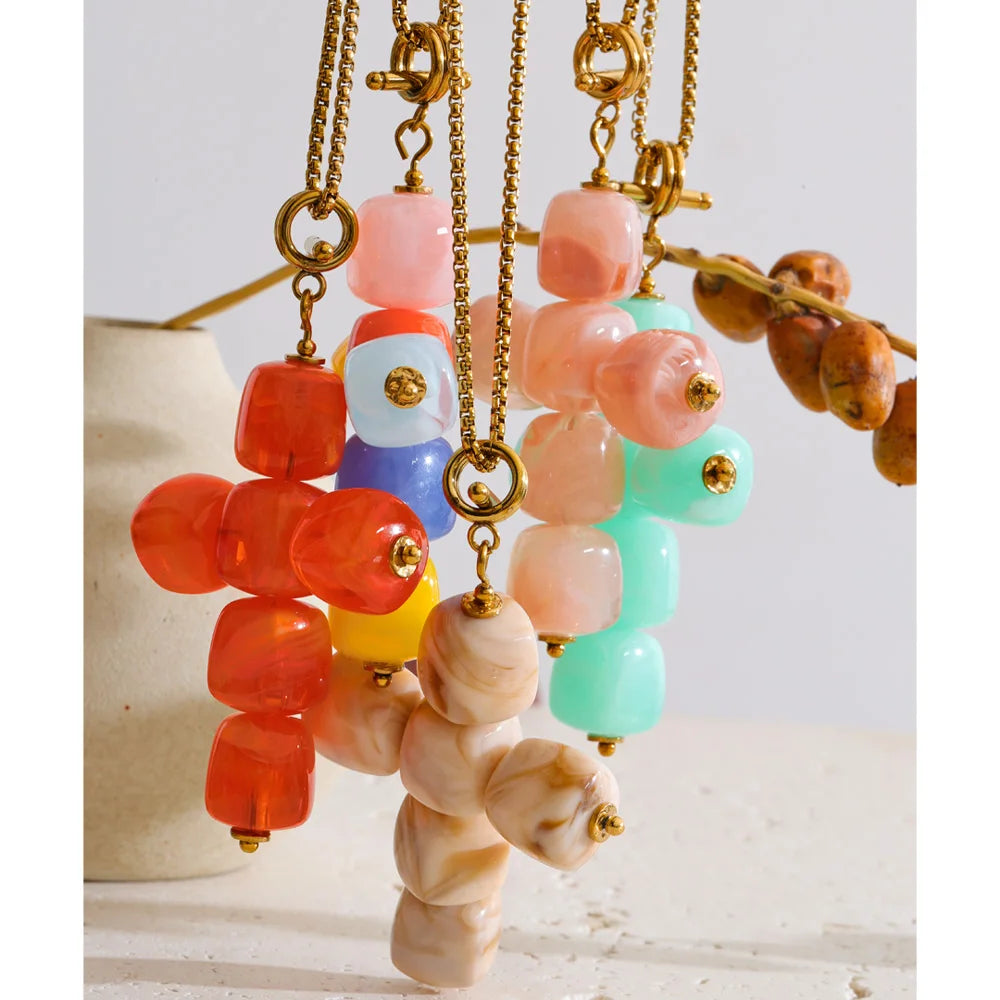 Resin acrylic cross necklace in gold-plated stainless steel with resin and acrylic.