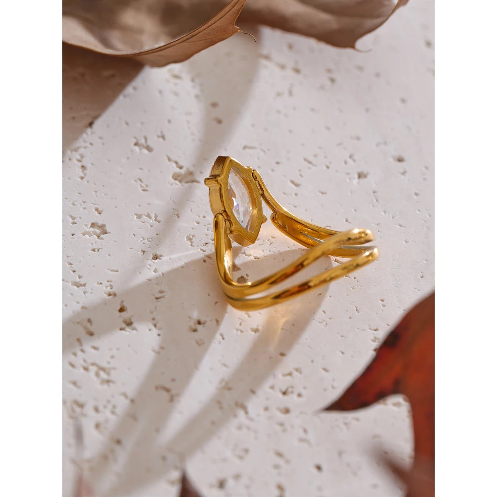 Cubic zirconia geometric ring in 18K gold-plated stainless steel with cubic zirconia.