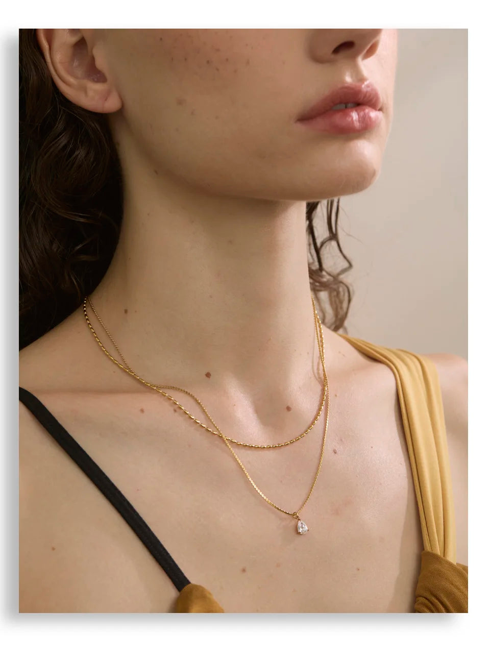 Cubic zirconia geometric layered necklace in gold-plated stainless steel with cubic zirconia.