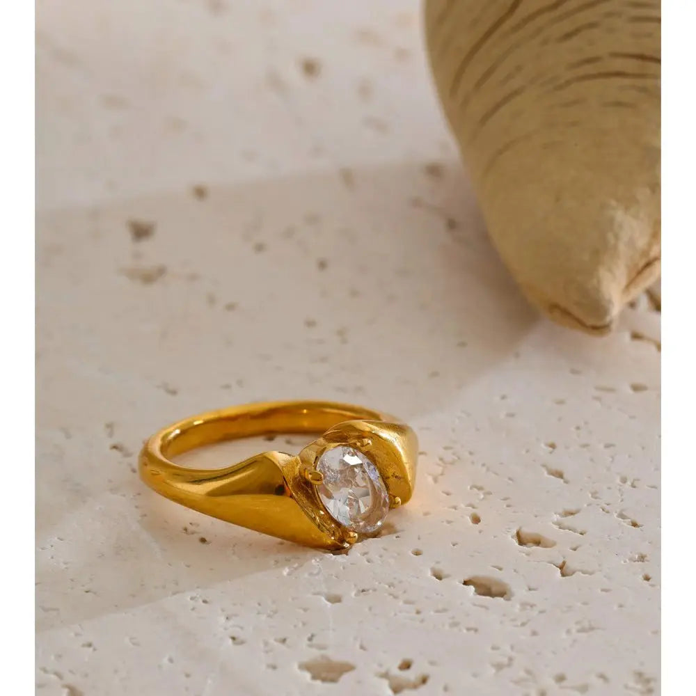 Cubic zirconia geometric ring in 18K gold-plated stainless steel with cubic zirconia.