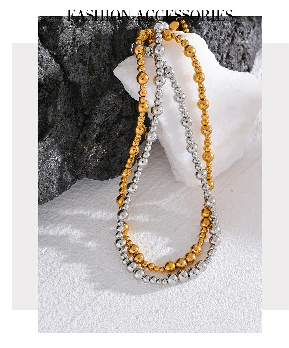 Beaded geometric chain necklace in gold-plated stainless steel.