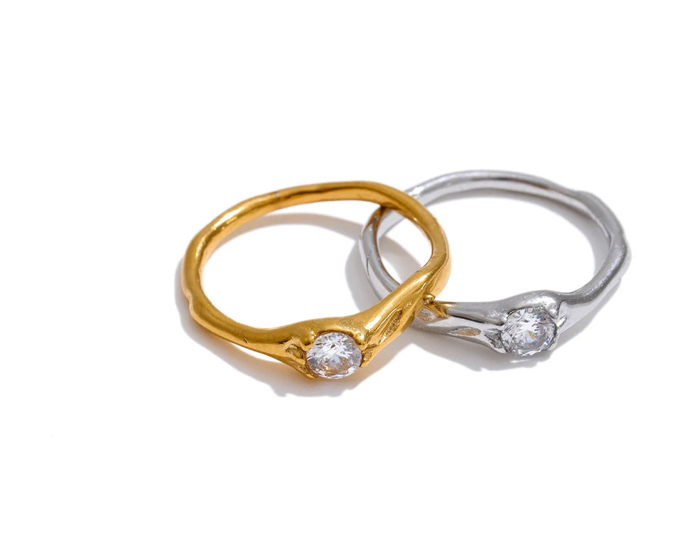 Cubic zirconia geometric ring in 18K gold-plated stainless steel with cubic zirconia.