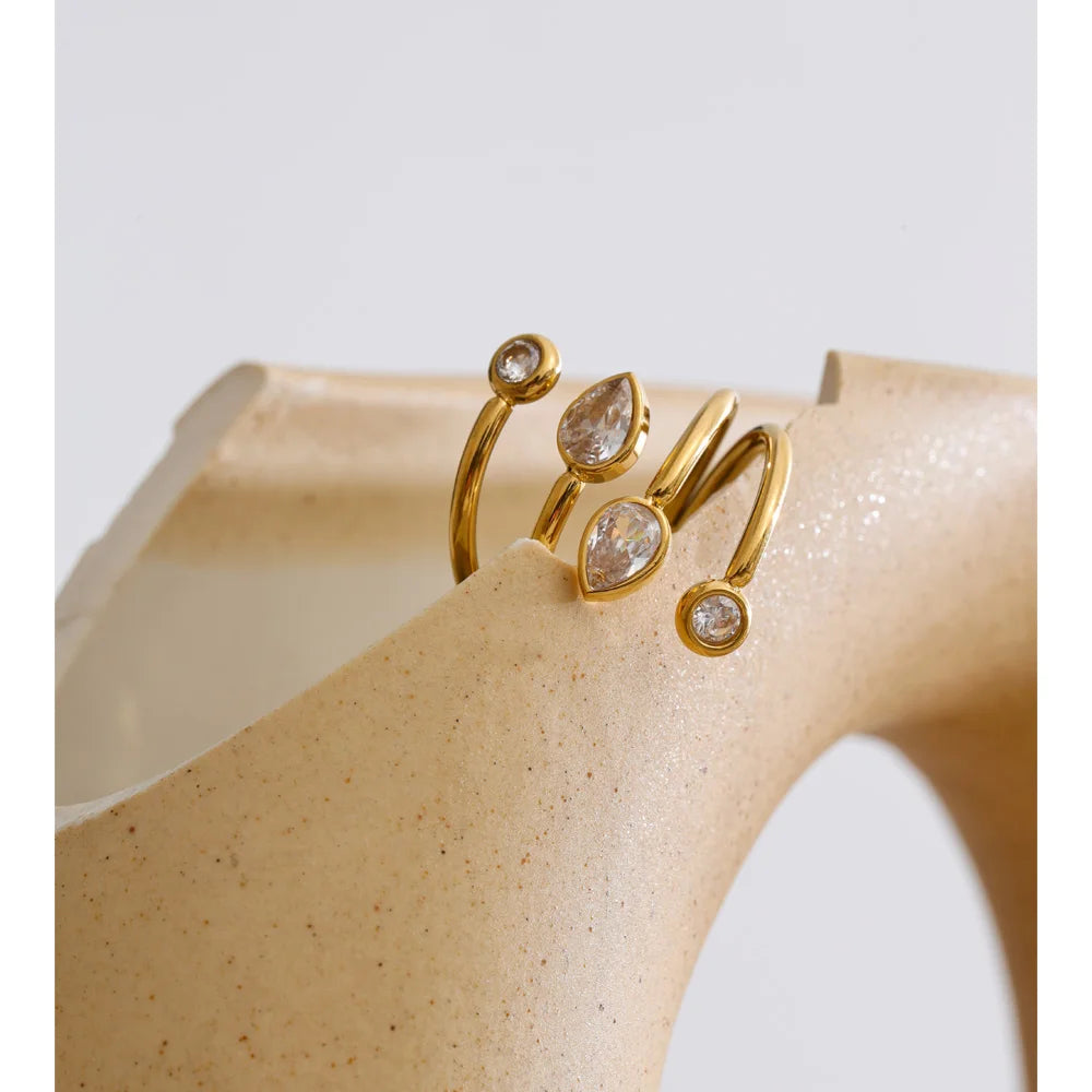 Cubic zirconia geometric layered ring in 18K gold-plated stainless steel with cubic zirconia.
