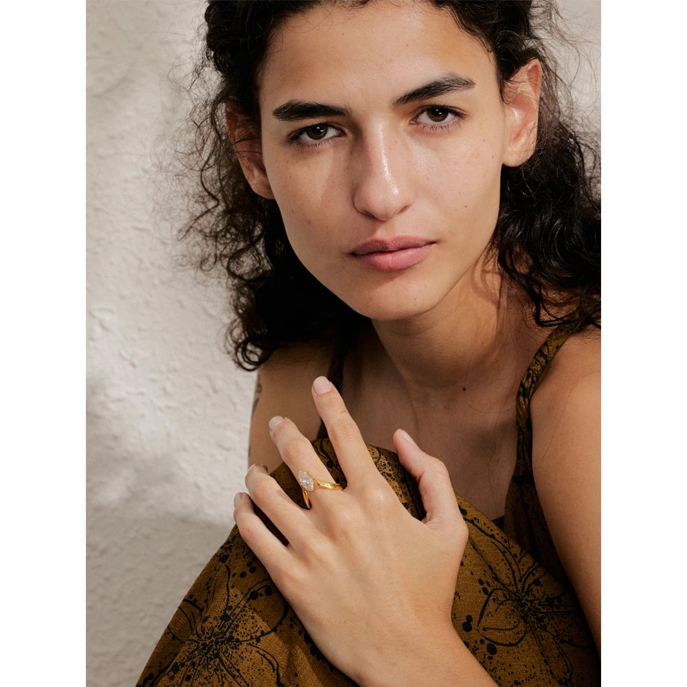Cubic zirconia geometric ring in 18K gold-plated stainless steel with cubic zirconia.