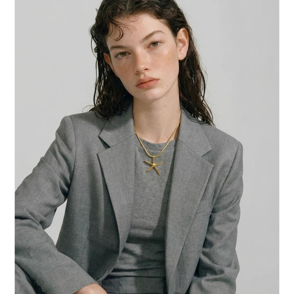 Star geometric necklace in gold-plated stainless steel.