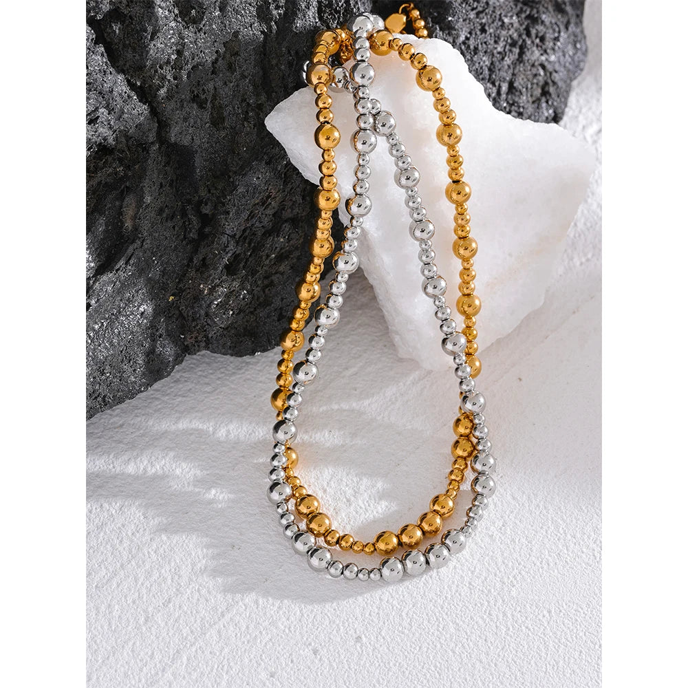 Beaded geometric chain necklace in gold-plated stainless steel.