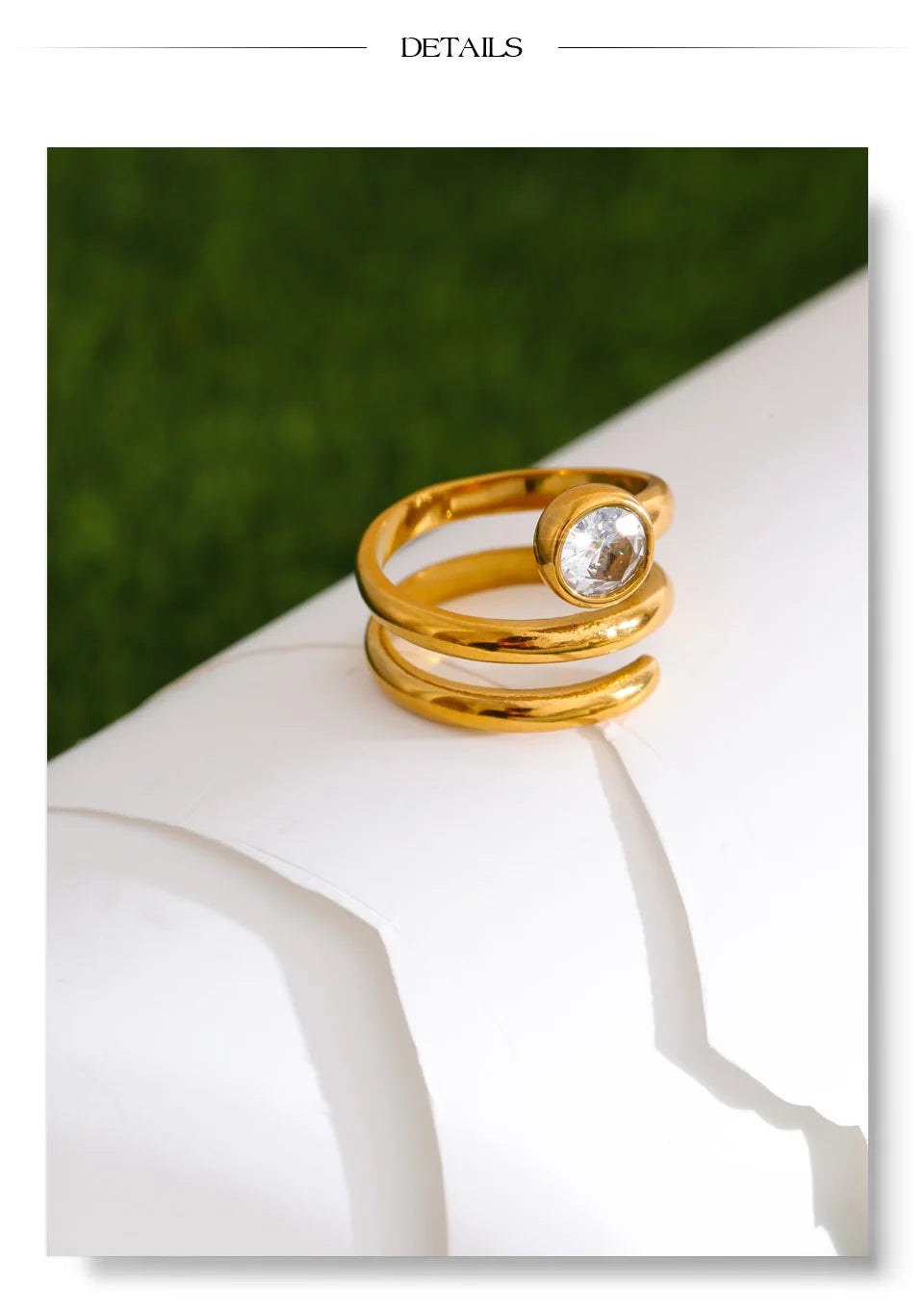 Cubic zirconia geometric layered ring in 18K gold-plated stainless steel with cubic zirconia.