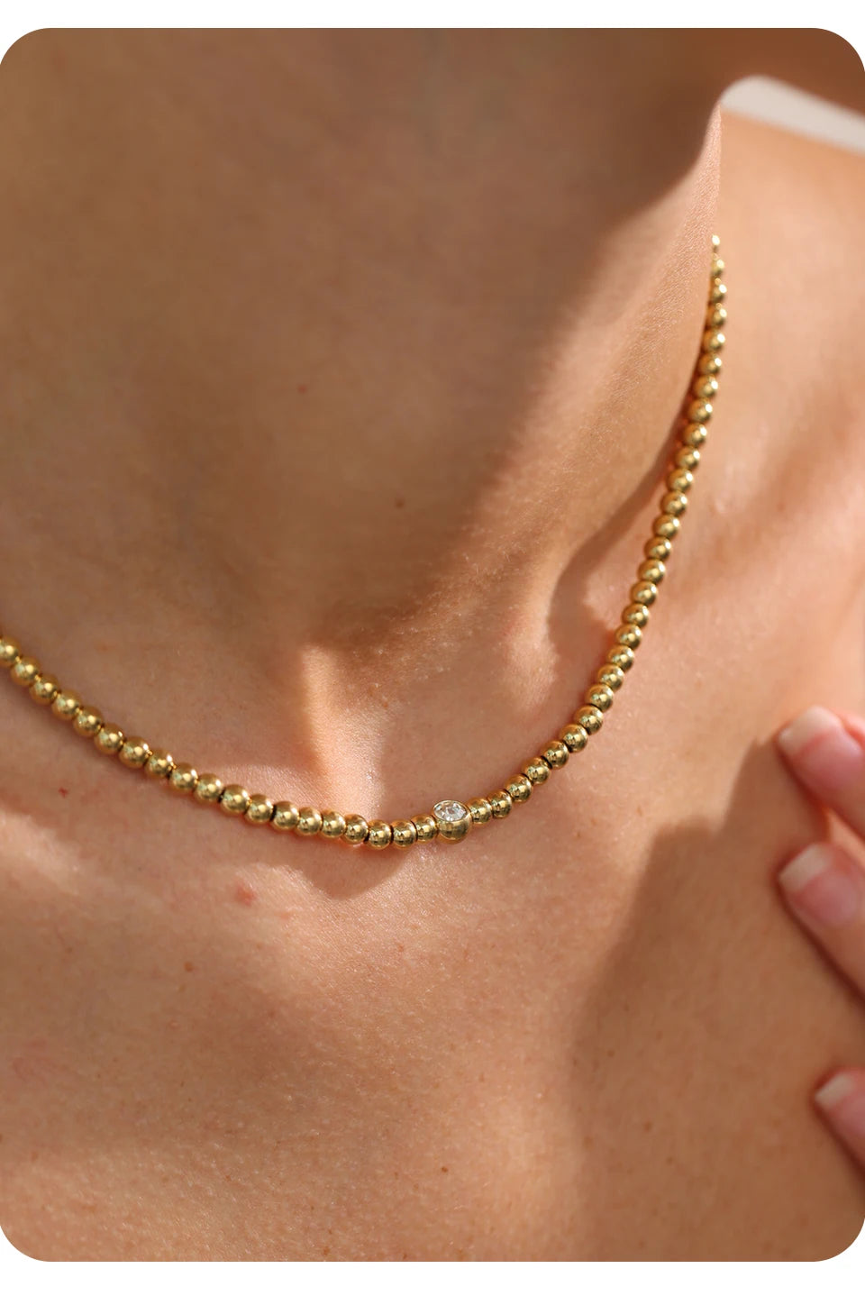 Cubic zirconia beaded geometric necklace in 18K gold-plated stainless steel with cubic zirconia.