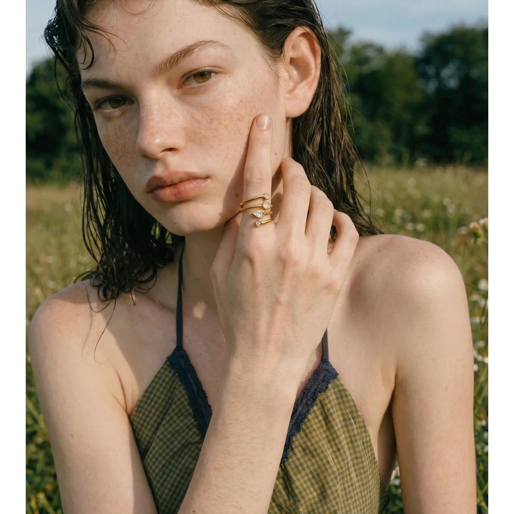Cubic zirconia geometric layered ring in 18K gold-plated stainless steel with cubic zirconia.