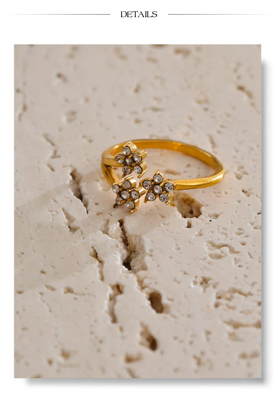 Cubic zirconia flower ring in 18K gold-plated stainless steel with cubic zirconia.