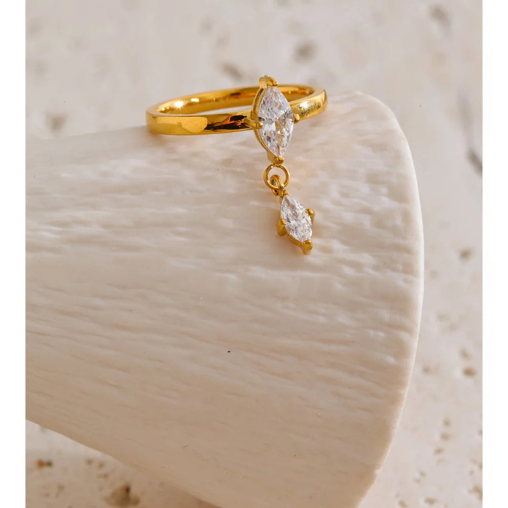 Cubic zirconia geometric ring in 18K gold-plated stainless steel with cubic zirconia.
