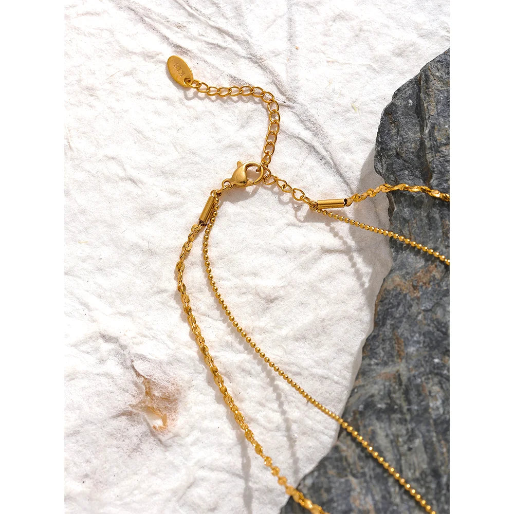 Geometric chain layered necklace in gold-plated stainless steel.