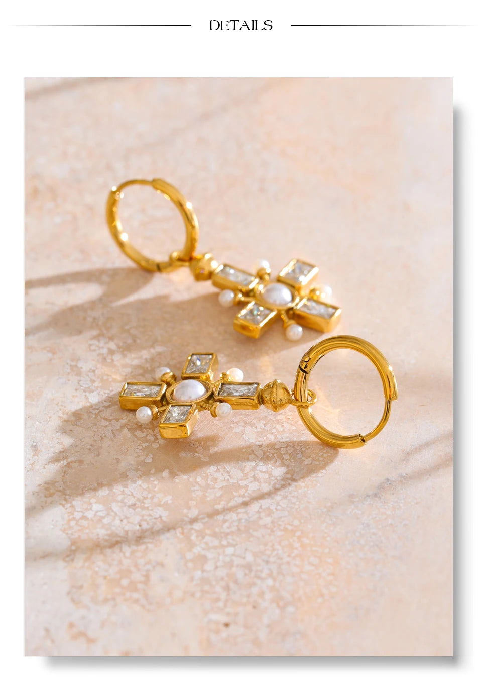 Cubic zirconia pearl cross earrings in gold-plated stainless steel with pearl and cubic zirconia.