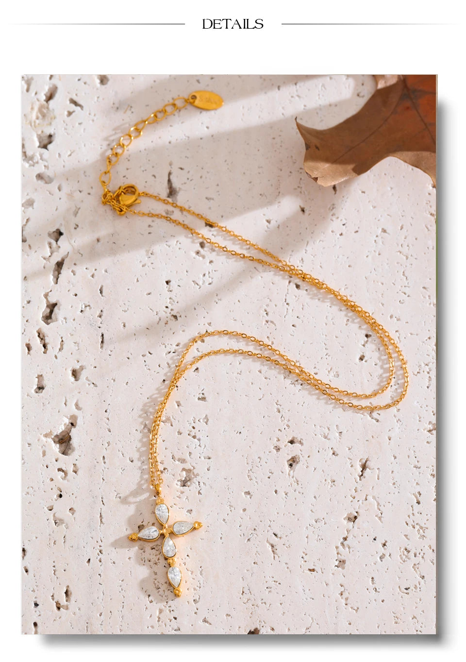 Cubic zirconia cross necklace in gold-plated stainless steel with cubic zirconia.