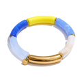 Resin acrylic geometric bracelet in gold-plated stainless steel with resin and acrylic.
