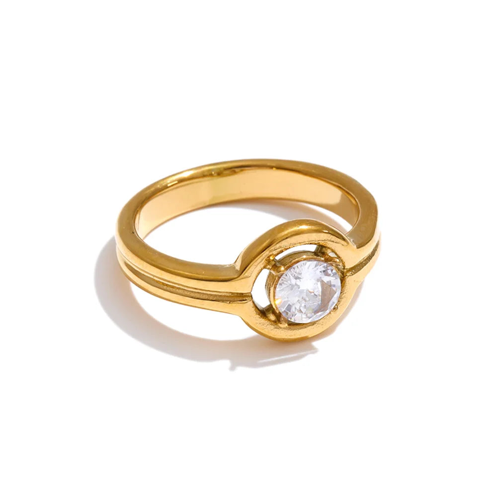 Cubic zirconia geometric ring in 18K gold-plated stainless steel with cubic zirconia.