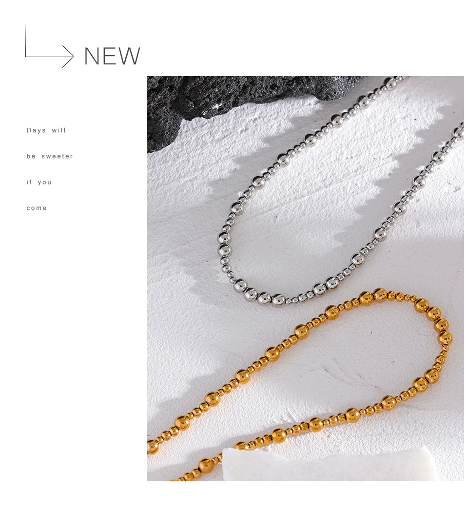 Beaded geometric chain necklace in gold-plated stainless steel.