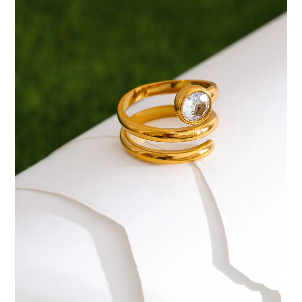 Cubic zirconia geometric layered ring in 18K gold-plated stainless steel with cubic zirconia.