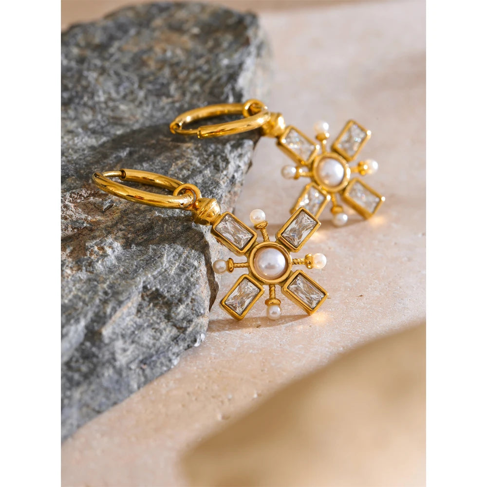 Cubic zirconia pearl cross earrings in gold-plated stainless steel with pearl and cubic zirconia.