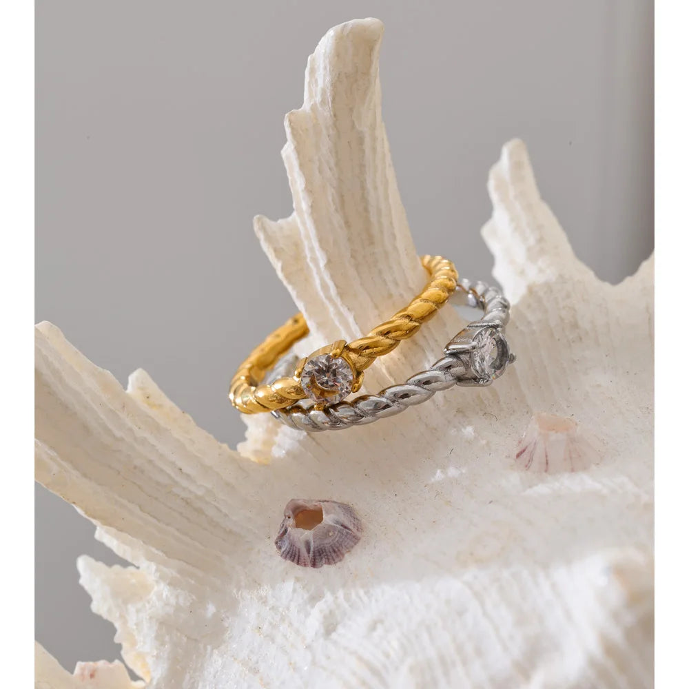 Cubic zirconia geometric ring in 18K gold-plated stainless steel with cubic zirconia.