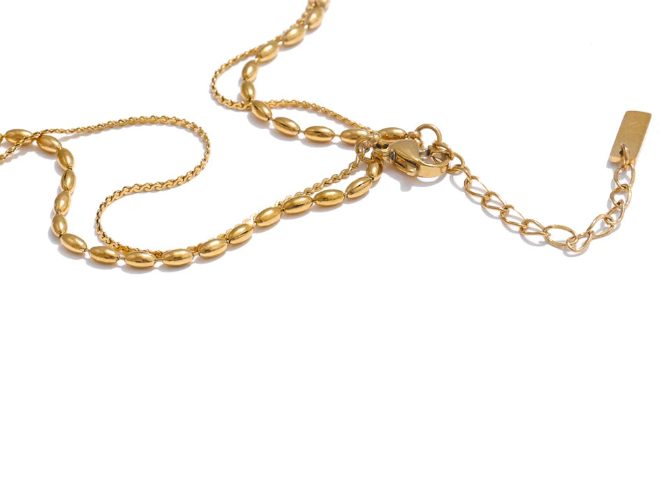 Geometric chain layered necklace in gold-plated stainless steel.