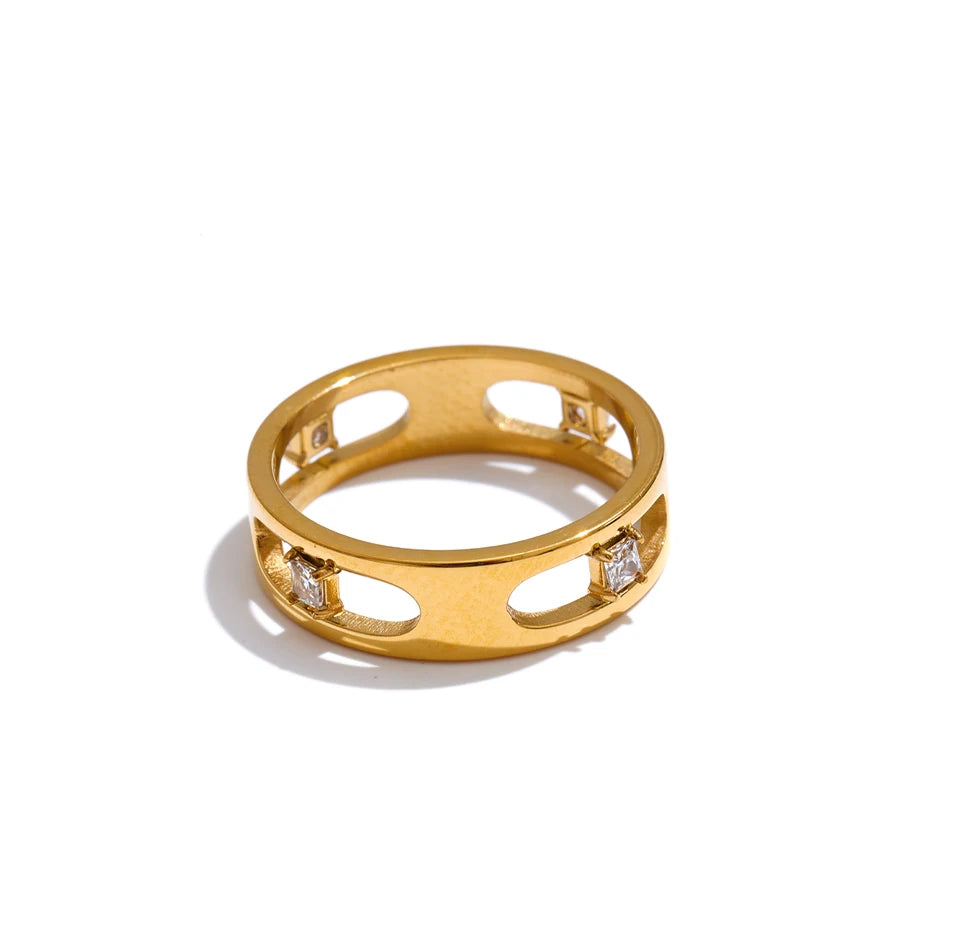Cubic zirconia geometric ring in 18K gold-plated stainless steel with cubic zirconia.