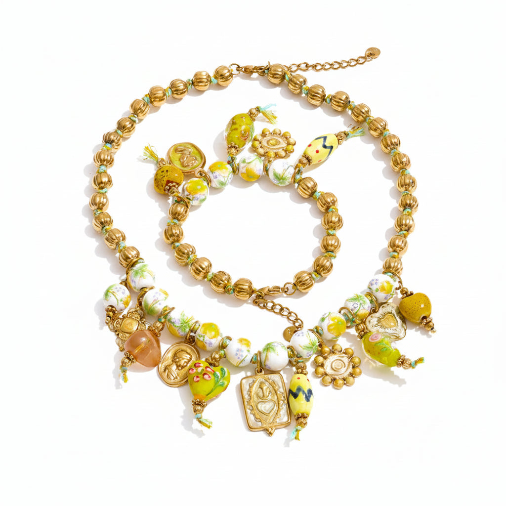 Gold-plated stainless steel necklace with beads and charms.