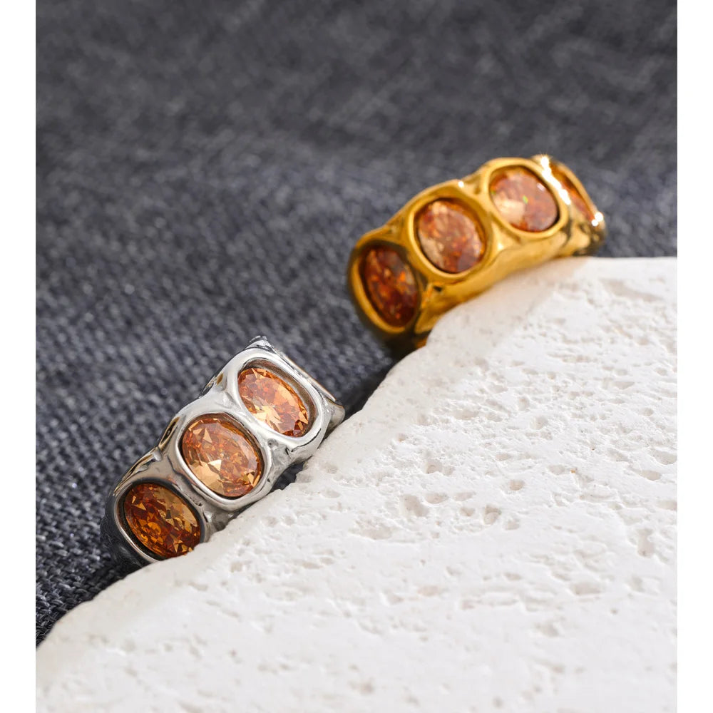 Cubic zirconia geometric ring in 18K gold-plated stainless steel with cubic zirconia.